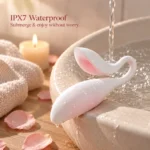 Coco Seed IPX7 waterproof vibrator with water droplets resting beside a ceramic basin